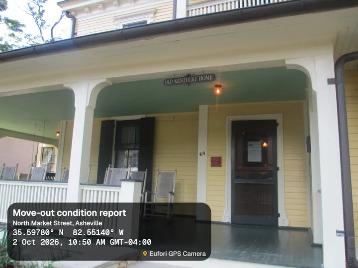Front porch of a yellow house with rocking chairs, with the Card stamp: Move-out condition report, North Market Street, Asheville