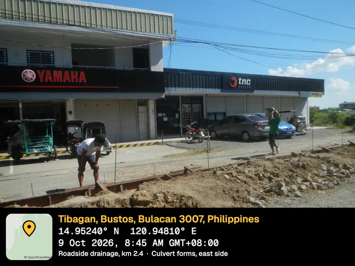 Roadside drainage works in front of shops, with the Night stamp: Tibagan, Bustos, Bulacan, Philippines, Roadside drainage, km 2.4